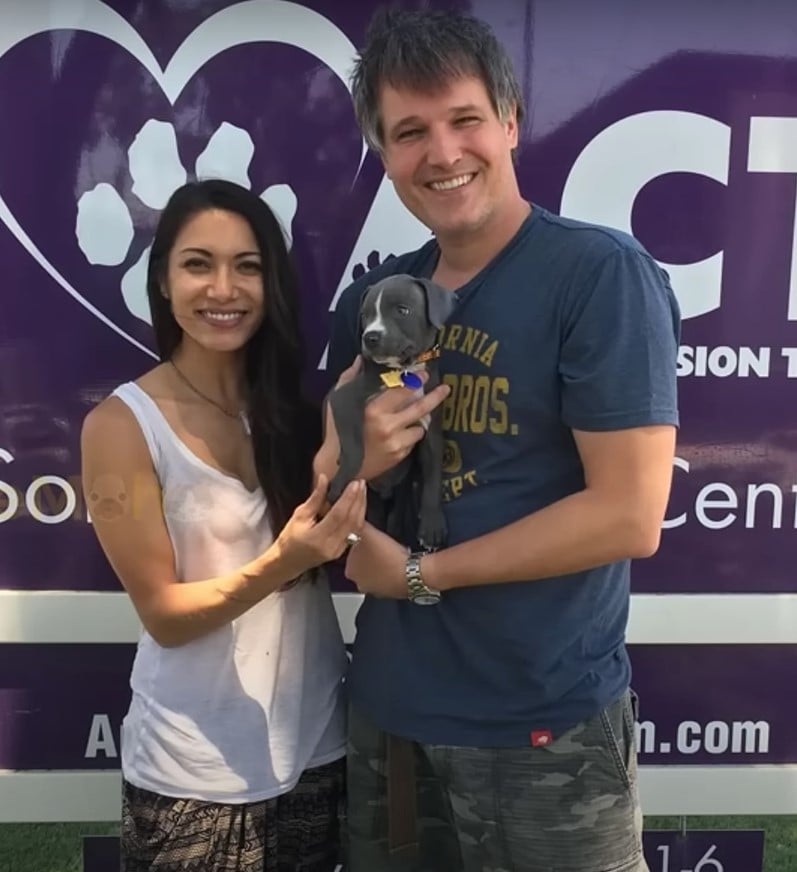 man and woman holding the puppy