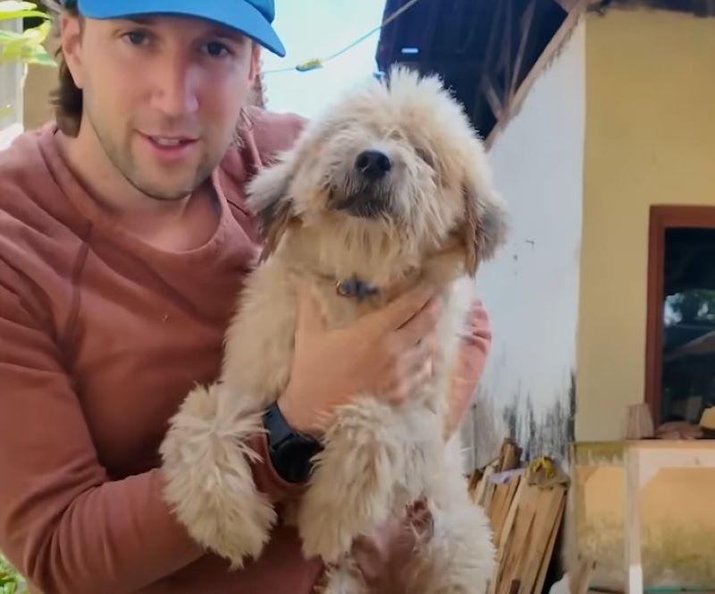 man holding a dog