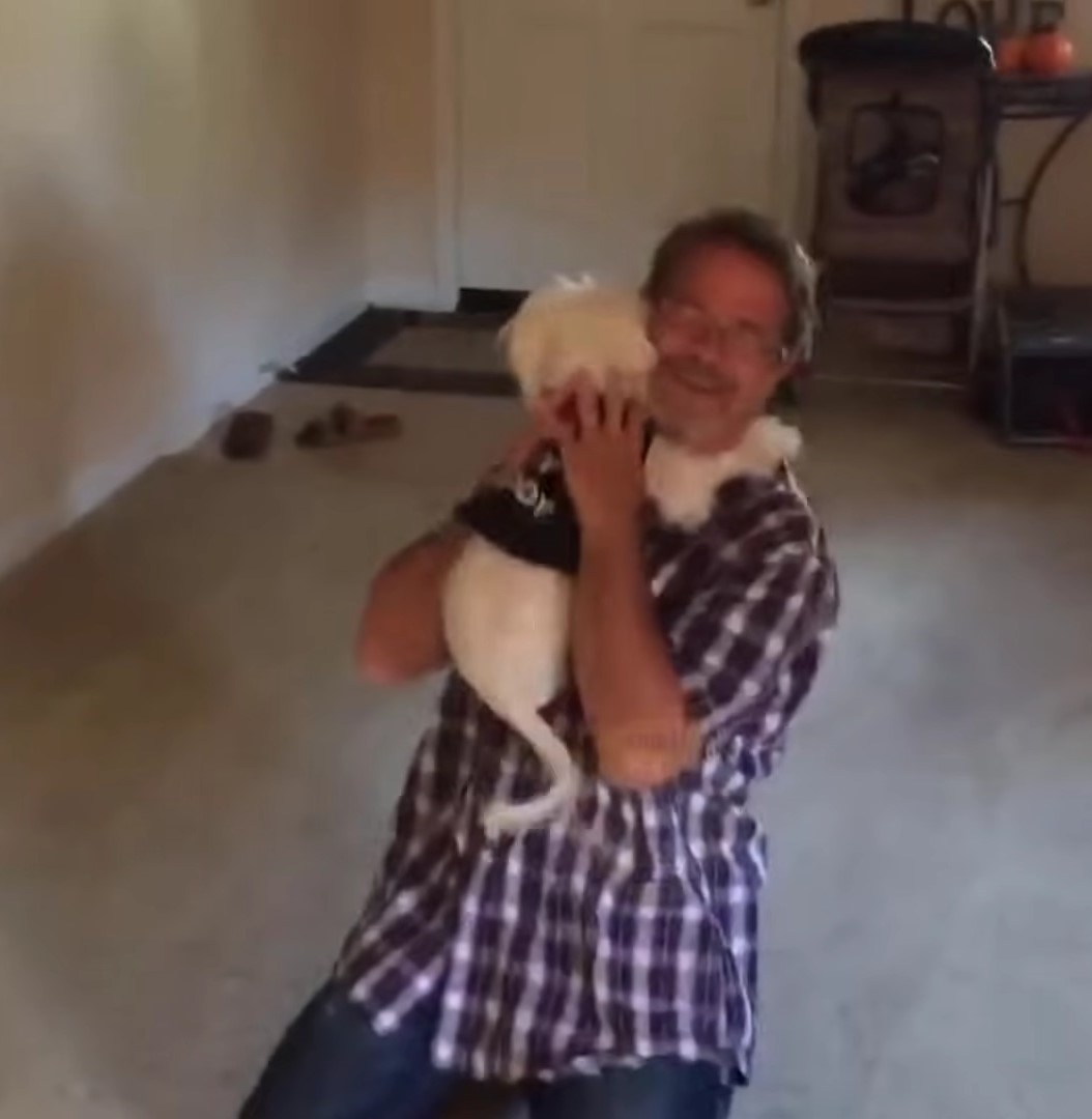 man hugging the dog