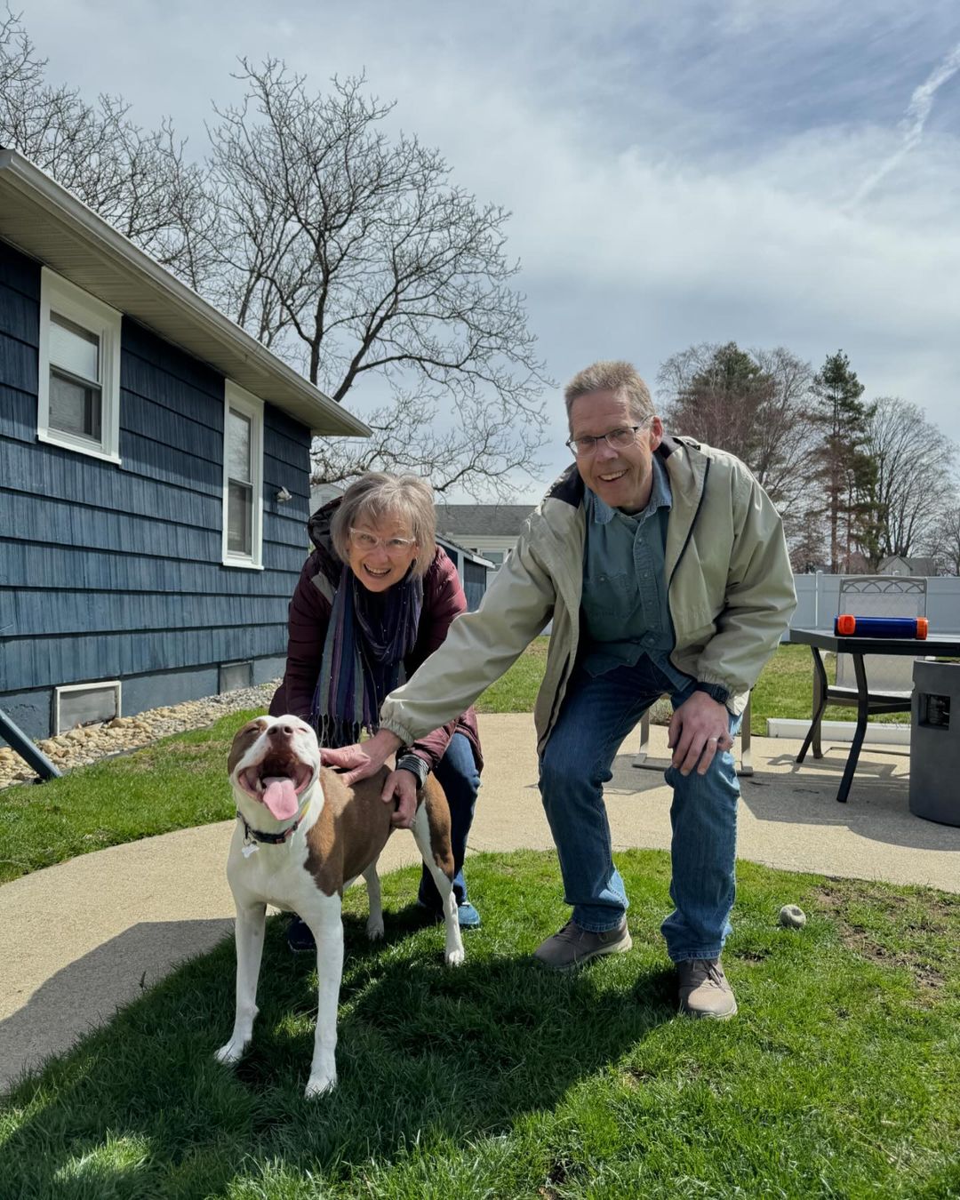 man, woman and pitbull