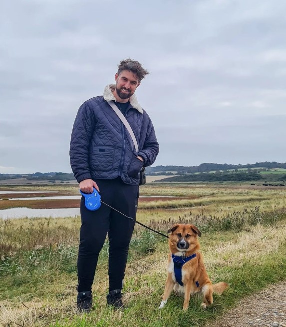 smiling man walking his dog