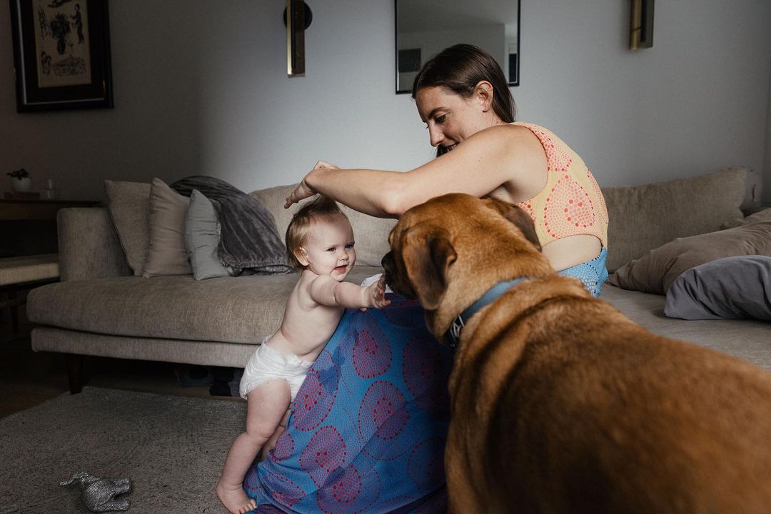 woman dog and baby in livingroom