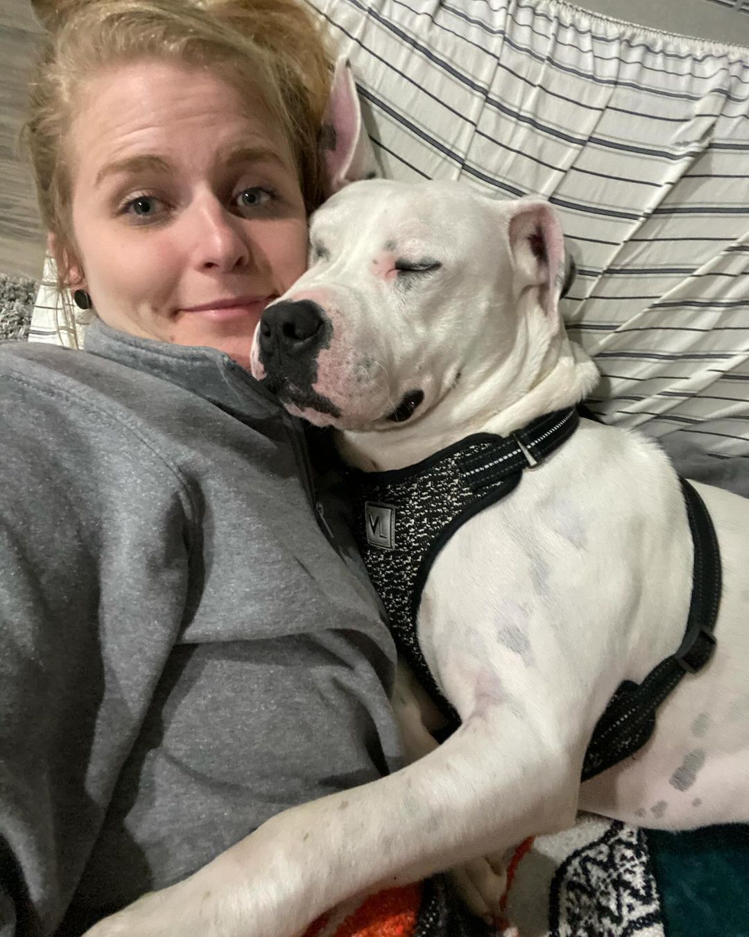 young woman lying with dog