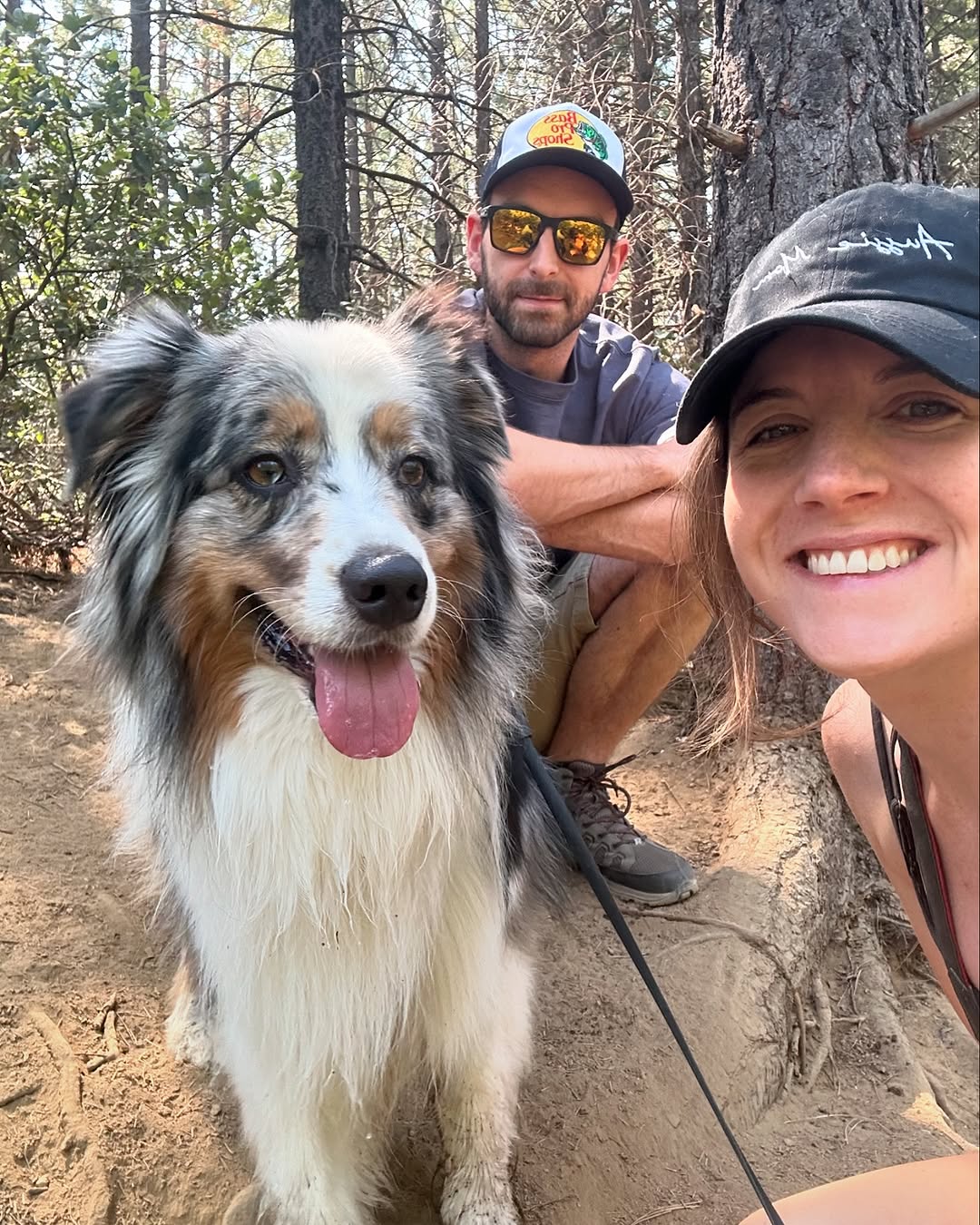 couple posing with dog on hiking