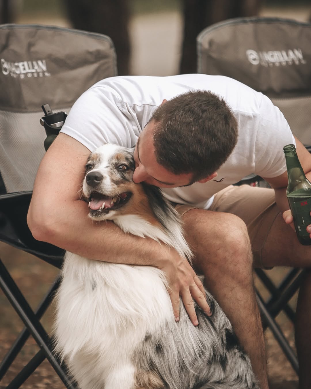 man kissing his dog