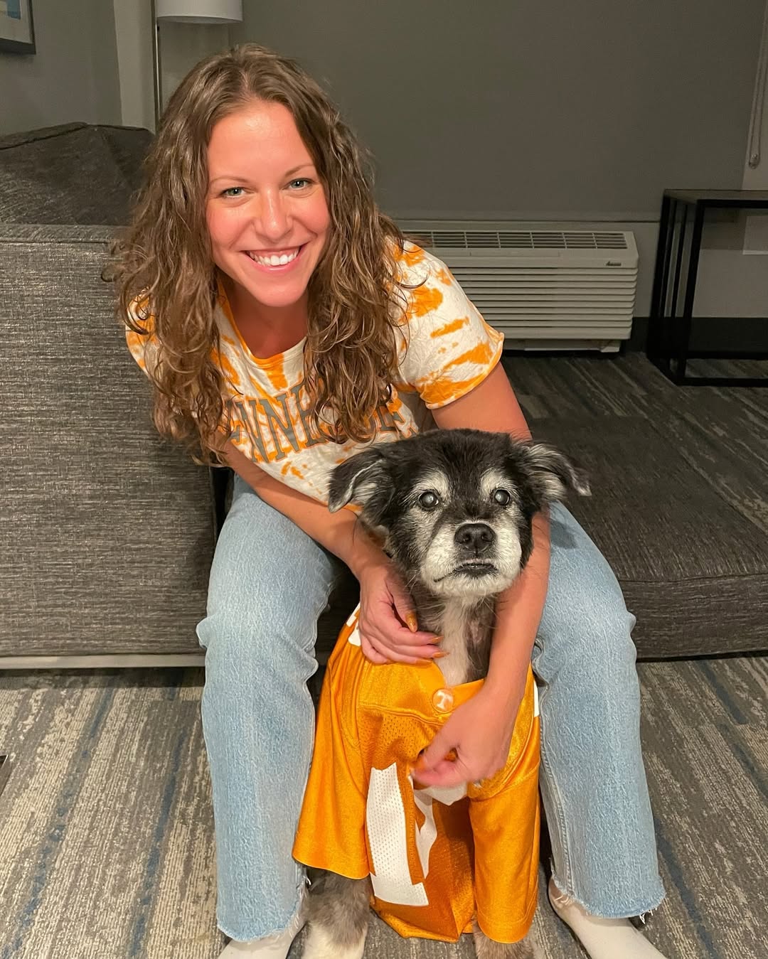 smiling woman posing with dog