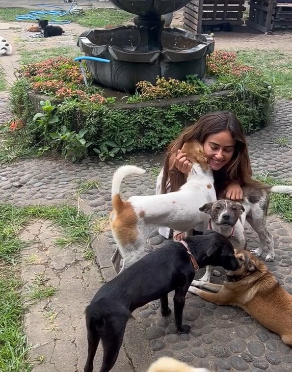 smiling woman with dogs outdoor