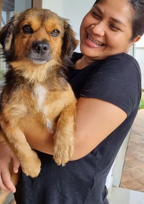 woman holding a dog