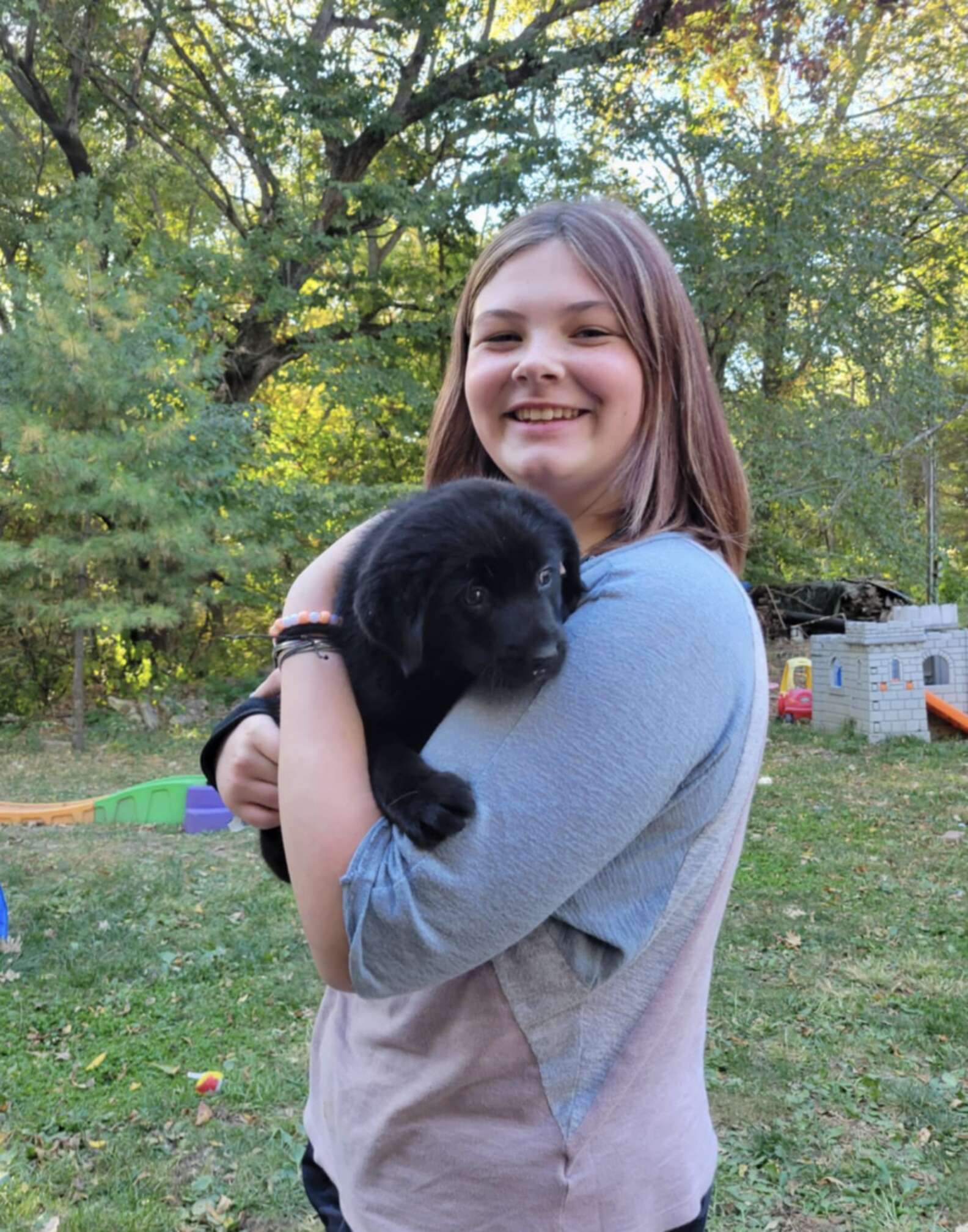 woman holding a puppy