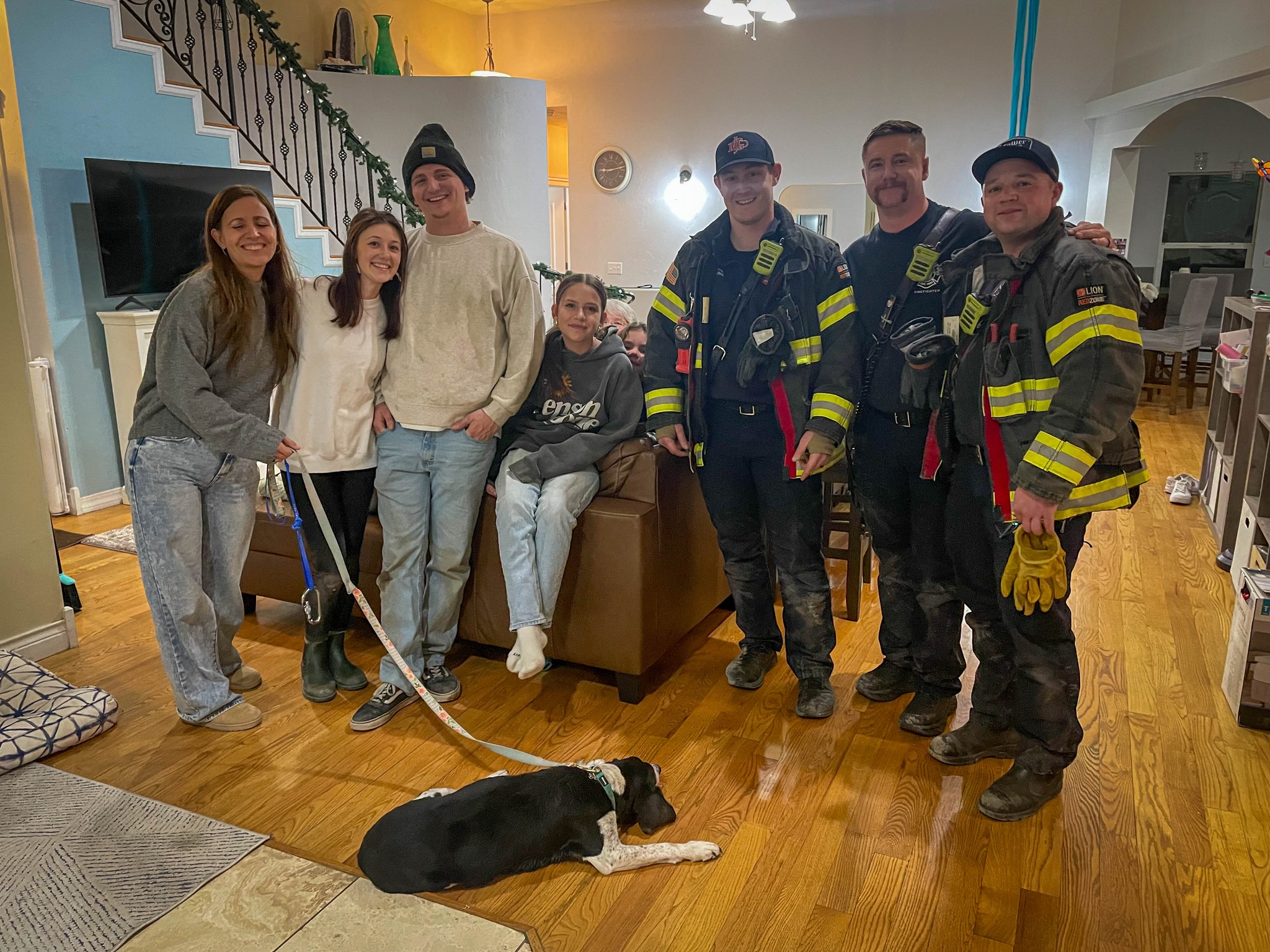 firefighters and family with dog