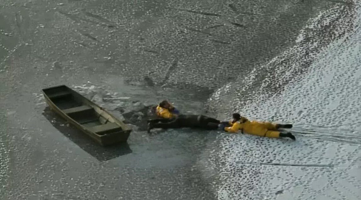 men swimming in icy lake