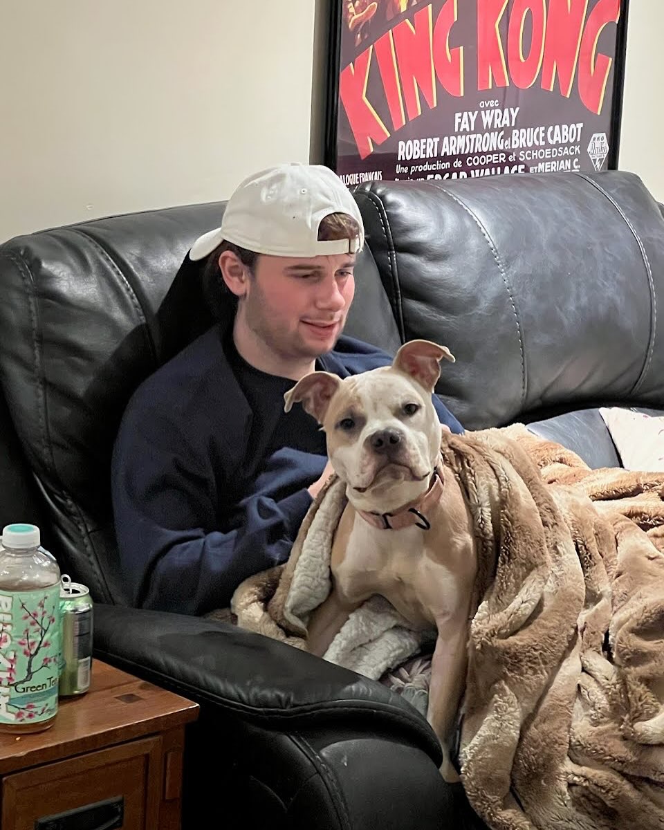 man with cap and dog