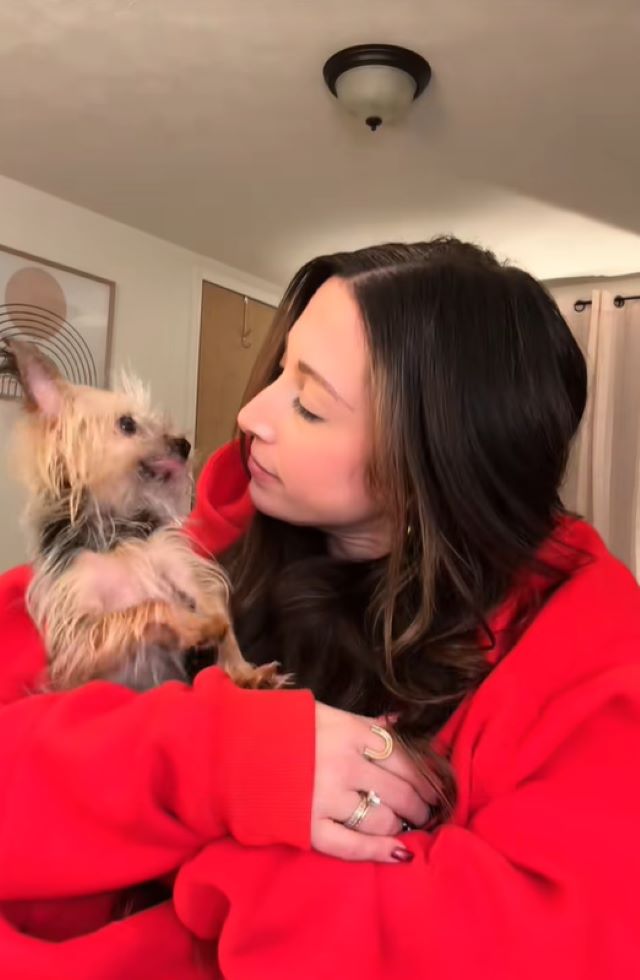 woman in hoodie and dog