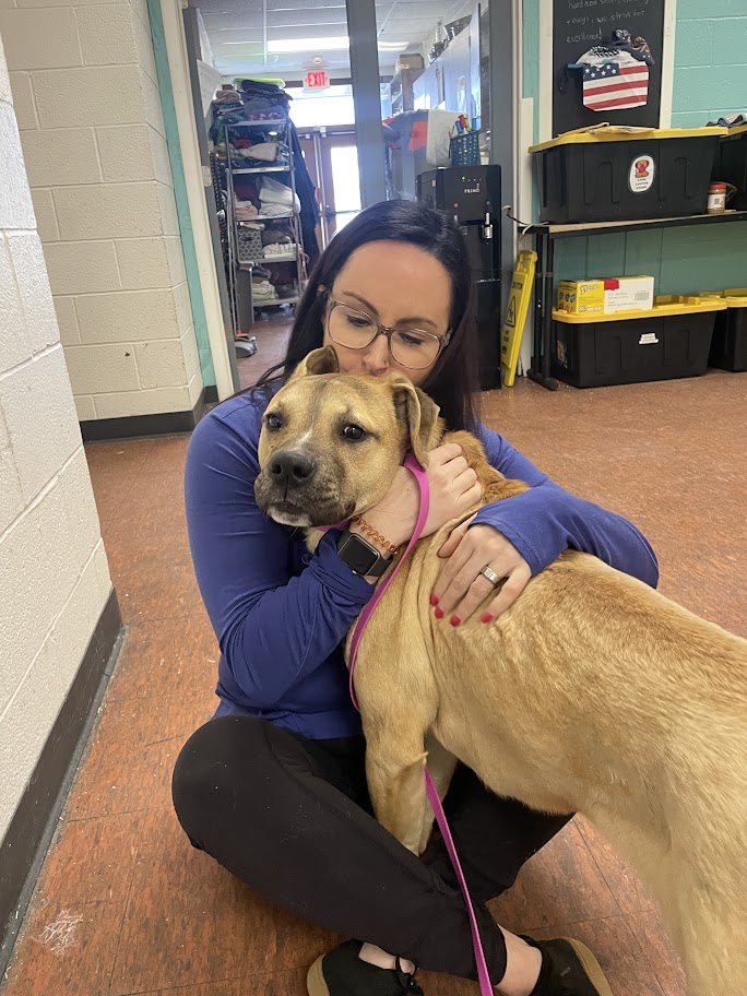 woman kissing a cute dog