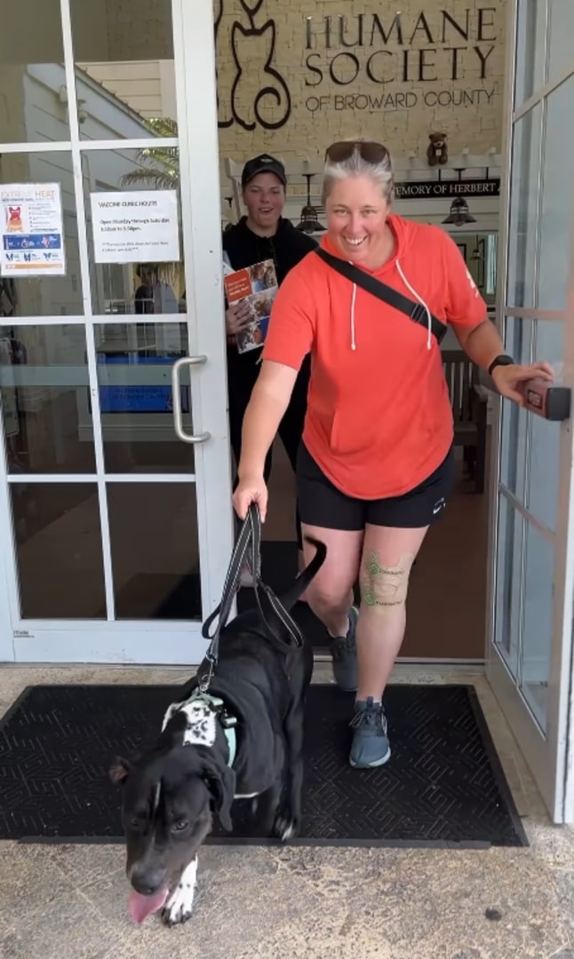 woman walking an adopted dog