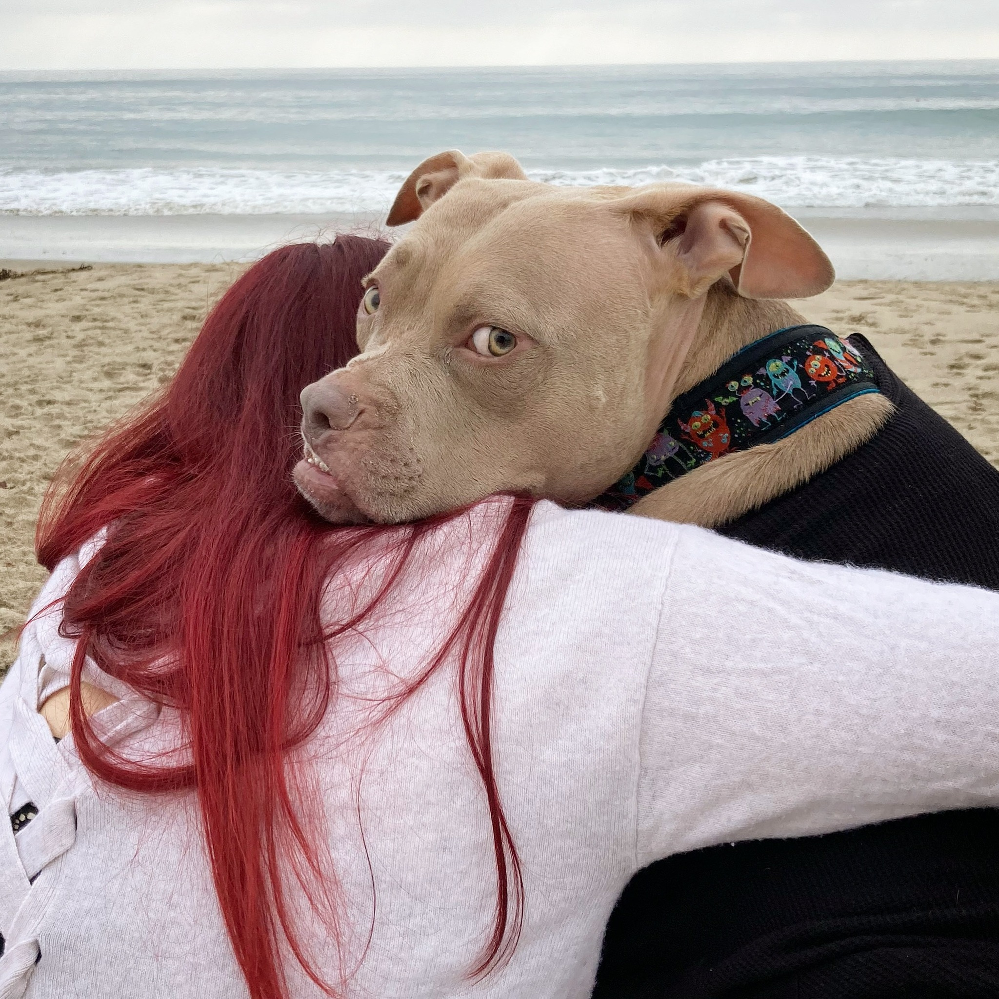 redhead woman hugging a dog