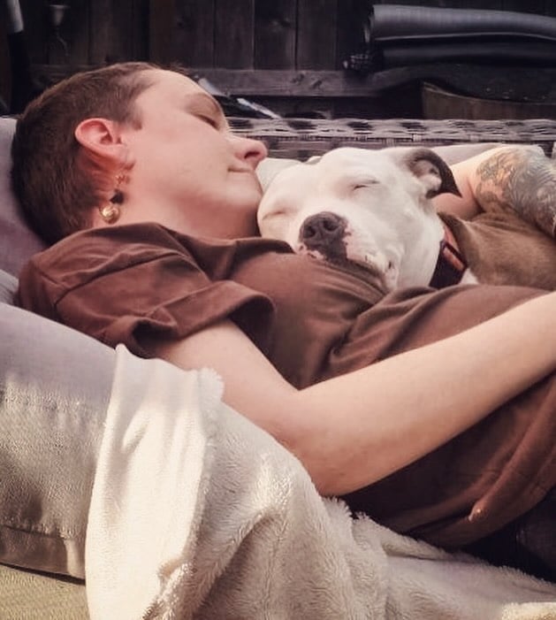 woman and dog sleeping together