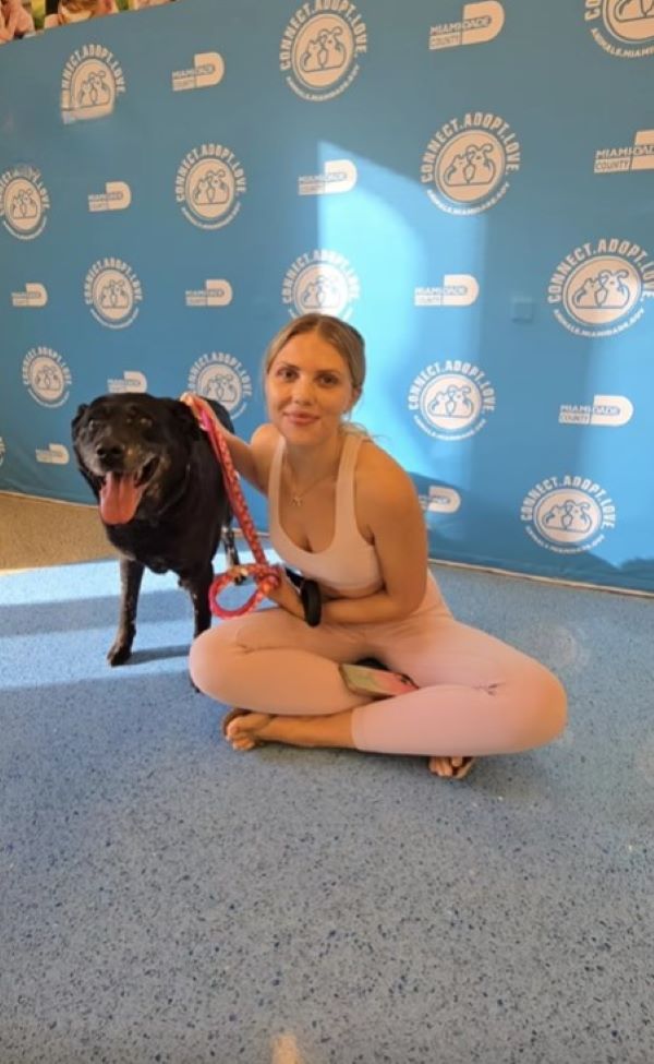 woman and happy black dog